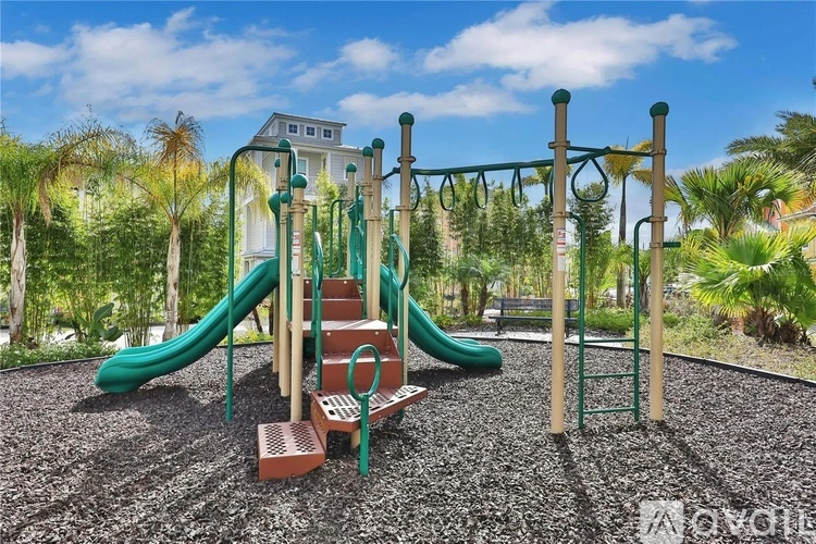 A playground with a green slide and a red brick structure.