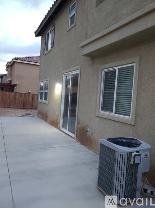 A house with a wall that is brown and tan with a window and a door.