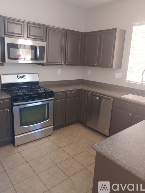 A kitchen with a stove top oven and microwave.