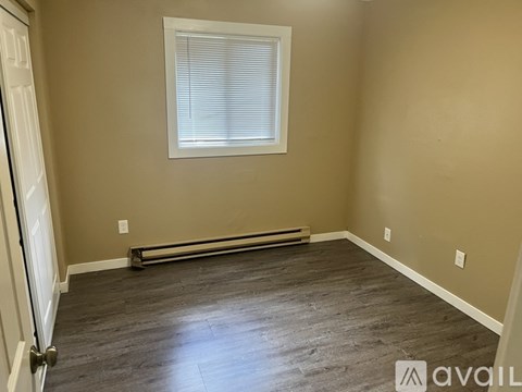 A room with a window and a radiator on the wall.