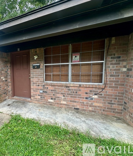 A red door with a sign on the window.