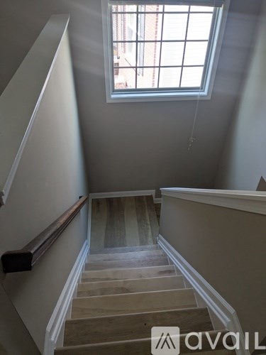 A staircase with a window above it.