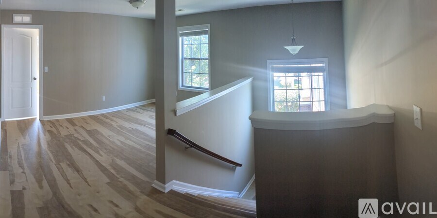A room with a wooden floor and a window.