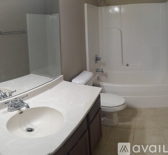 A bathroom with a white sink, toilet, and bathtub.