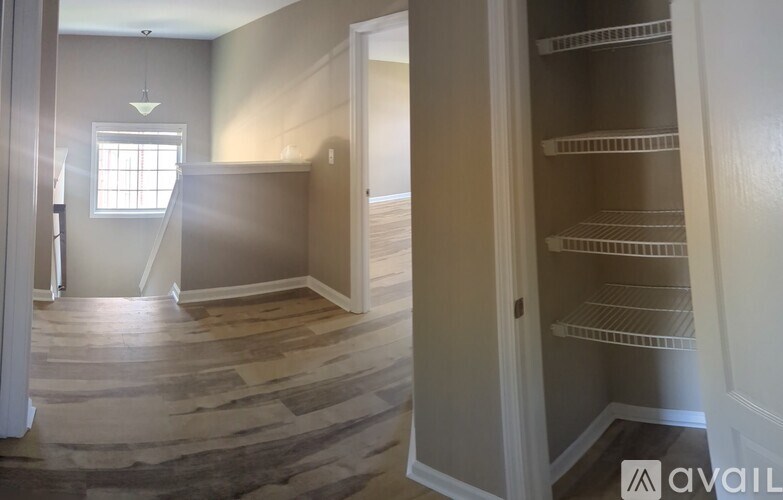 A room with a wooden floor and a window.