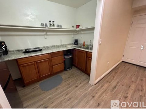 A kitchen with wooden cabinets and a white countertop.