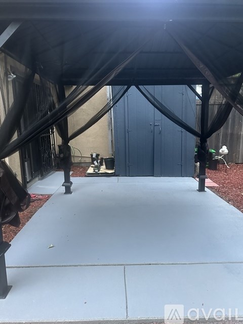 A large black tent is set up in front of a building.