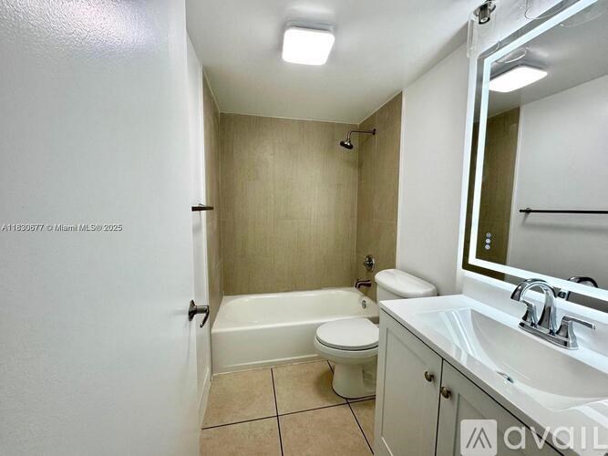 A bathroom with a toilet, sink, and bathtub.