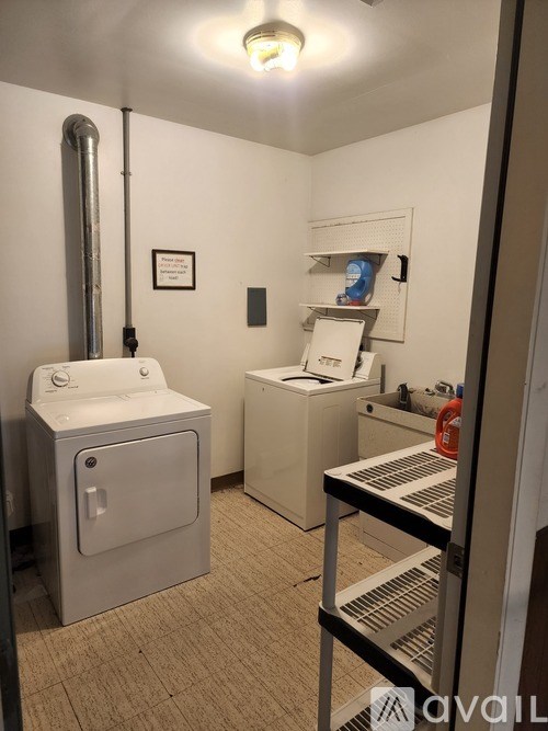 A white toilet and sink in a small bathroom.