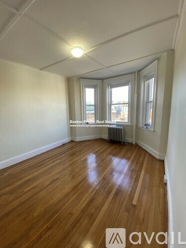 A room with wooden floors and white walls.