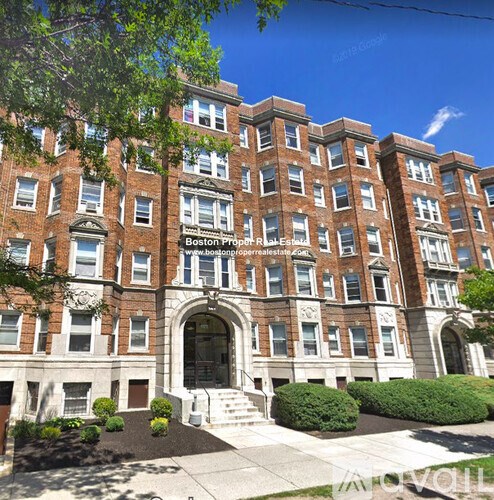 A large red brick building with a sign that says Boston Property Estate.