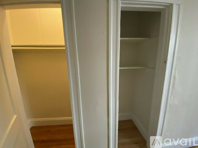 A white doorway leads to a room with a wooden floor.