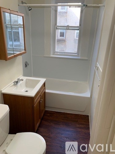 A small bathroom with a toilet, sink, and bathtub.
