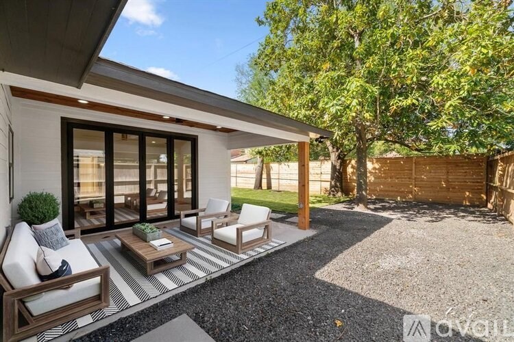 A patio area with a table and chairs is shown.