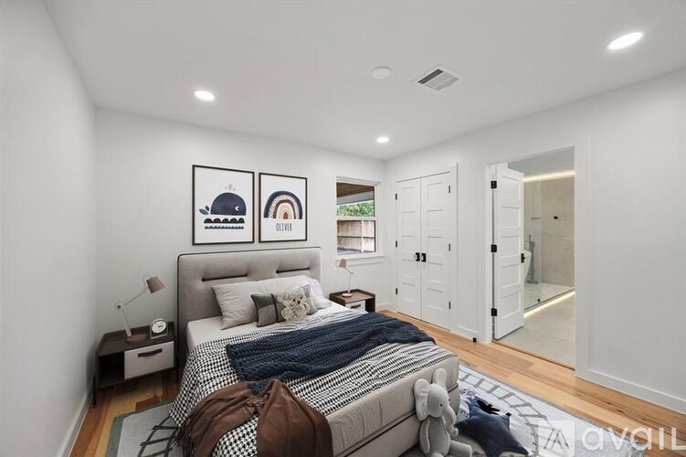 A bedroom with a bed, nightstand, and two pictures on the wall.