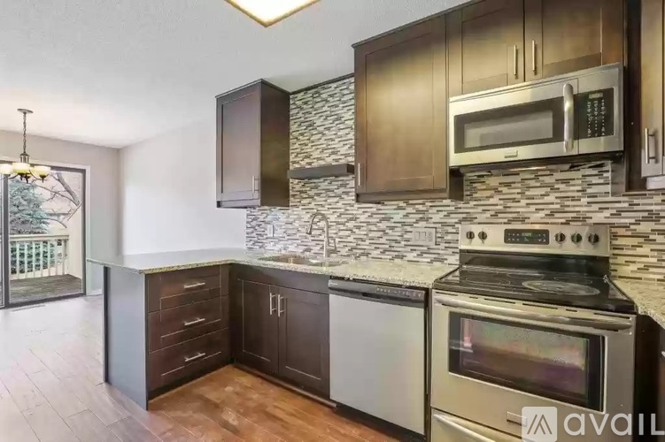 A kitchen with a stove top oven and microwave above it.