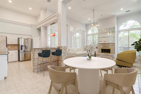 A modern kitchen with a dining table and chairs.