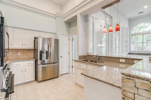 A kitchen with granite countertops and stainless steel appliances.