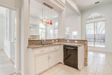 A kitchen with a granite countertop and a black oven.