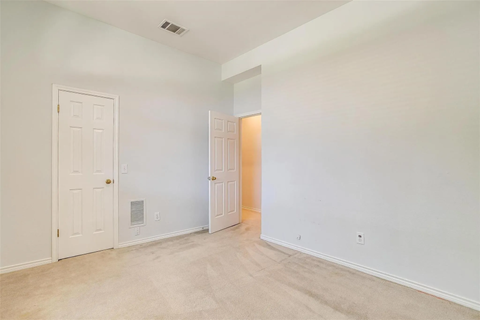 A room with a white door and a white wall.