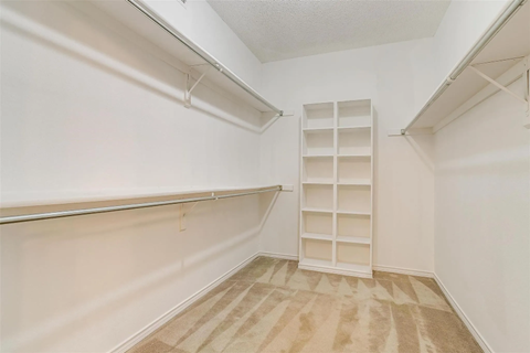 A room with a white wall and a white shelving unit.