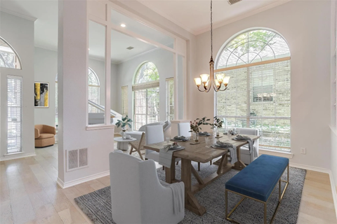 A dining room with a table set for six people.