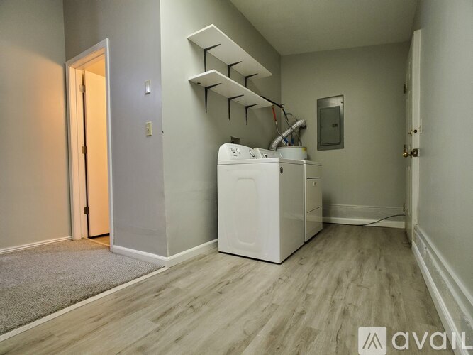 A small, empty room with a washer and dryer.