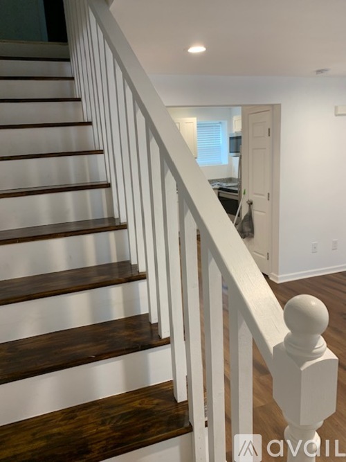 A room with wooden floors and white walls.