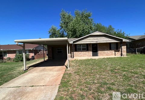 A house with a covered patio and a driveway.