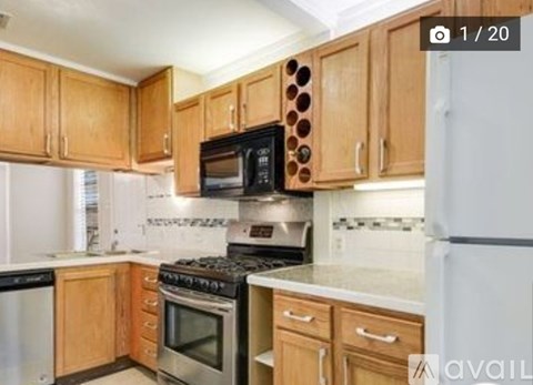 A kitchen with wooden cabinets and a white refrigerator.
