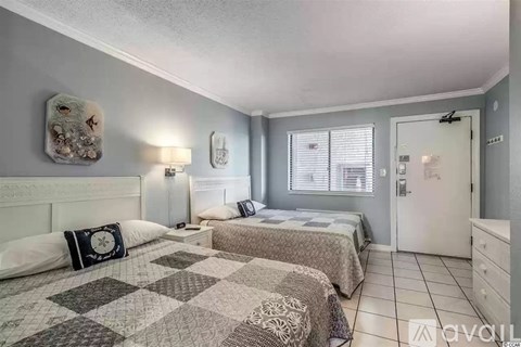 A bedroom with two beds and a dresser.
