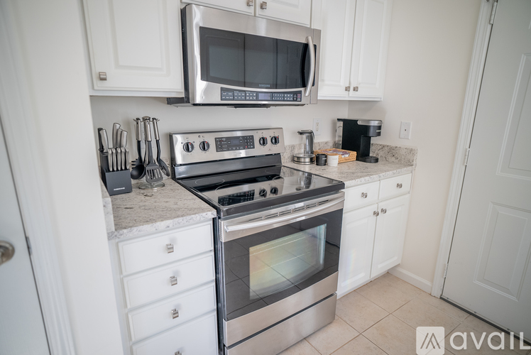 A kitchen with a stainless steel oven and microwave above it.