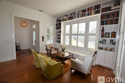 A living room with a white couch and a wooden table.