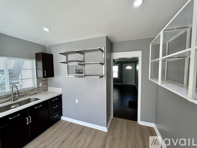 A kitchen with a white countertop and a stove top oven.