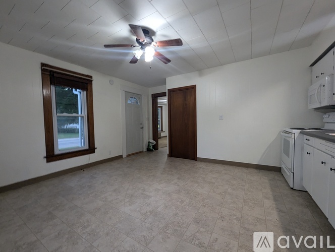 A kitchen area with a fan and a window.