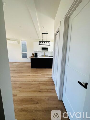 A long hallway with a kitchen area at the end.