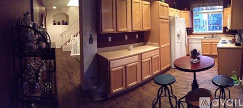 A kitchen with wooden cabinets and a white refrigerator.