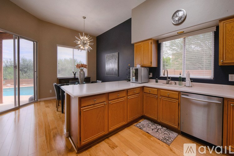 A kitchen with wooden cabinets and a large island.