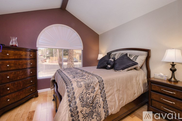 A bedroom with a bed, nightstand, and a dresser.