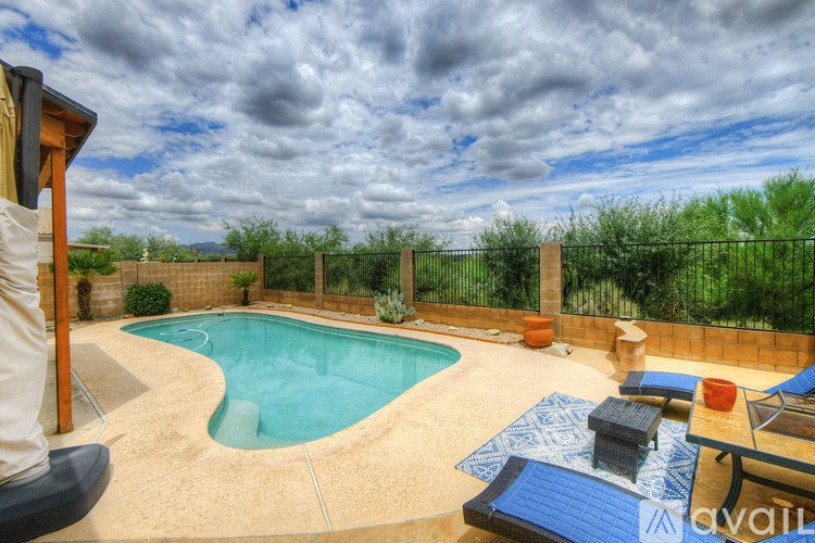 A swimming pool with a blue mat and a wooden deck.