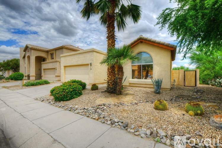 A house with a palm tree in front of it.
