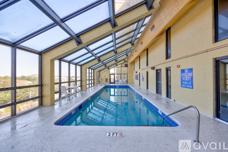 A large indoor swimming pool with a glass ceiling.