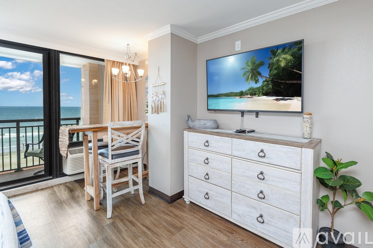 A living room with a television displaying a beach scene.