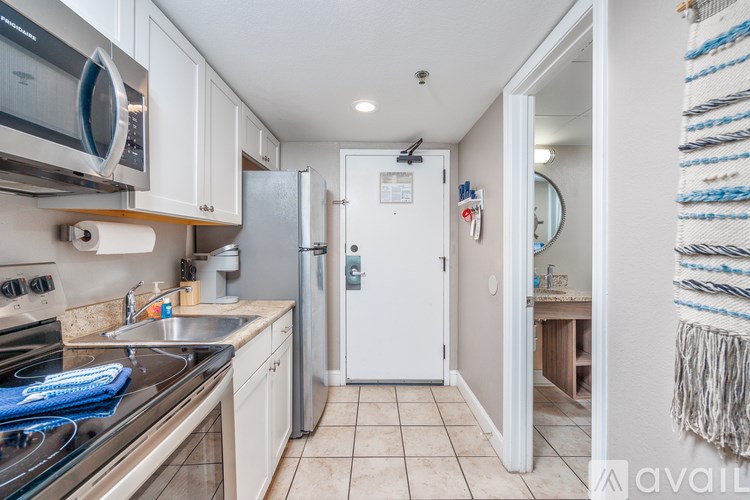 A kitchen with white appliances and a white refrigerator.