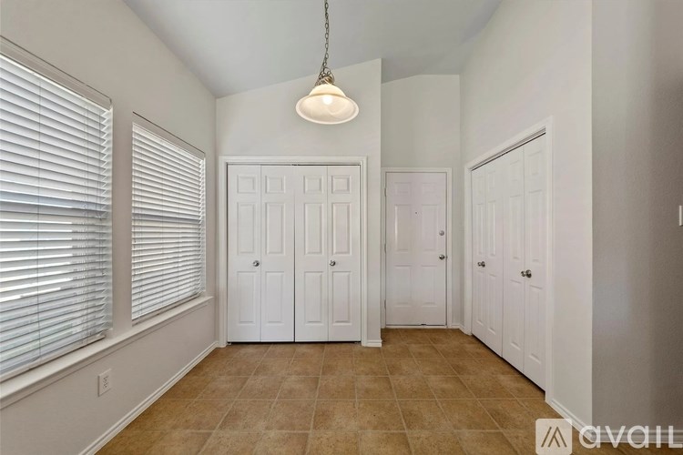 A room with white doors and a light hanging from the ceiling.
