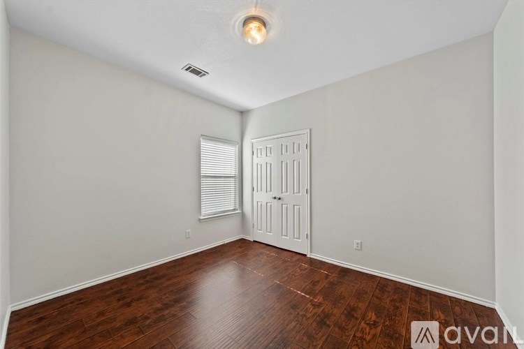 A room with wooden floors and a white door.