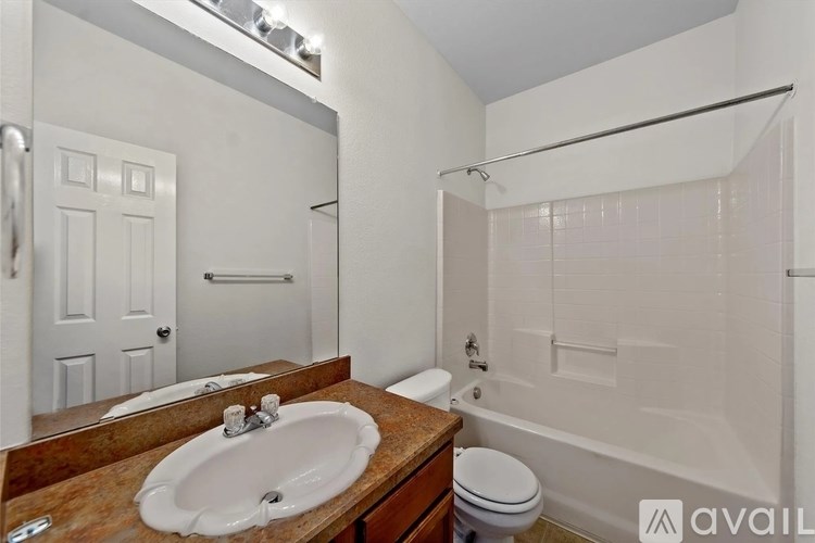 A bathroom with a sink, toilet, and bathtub.
