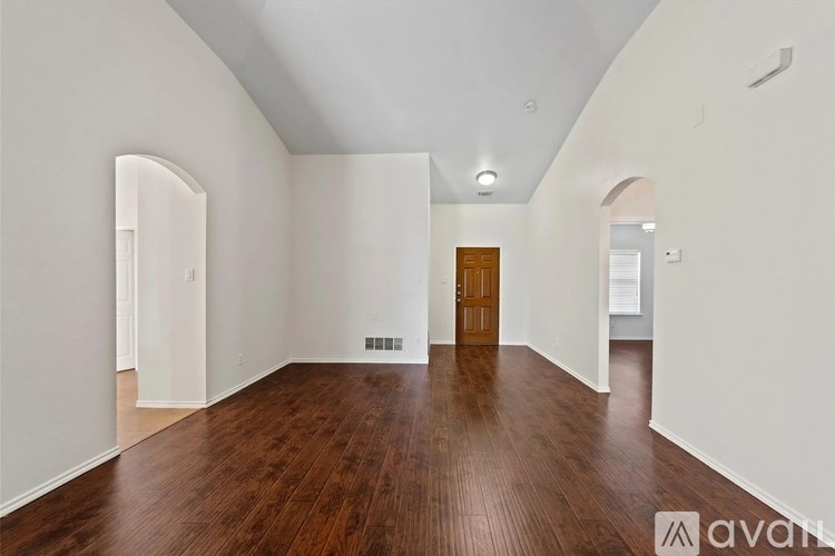 A room with wooden floors and white walls.