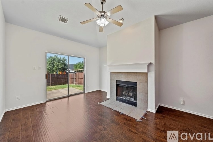 A living room with a fireplace and sliding glass doors.