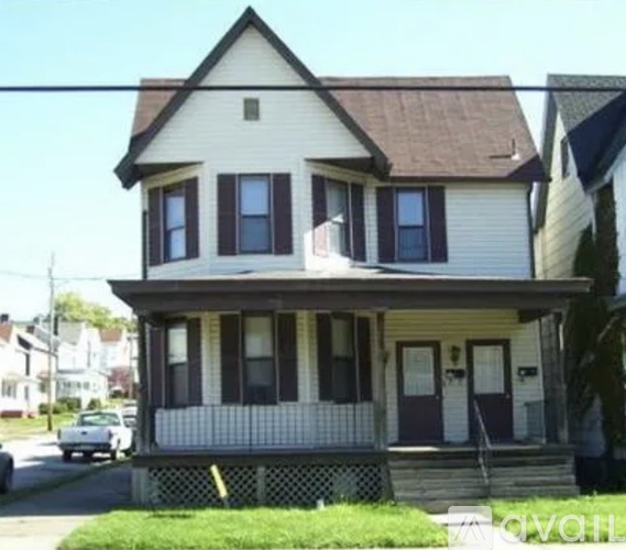 A two-story house with a white front porch.